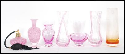 A collection of retro pink studio glass to include a pair of pink glass Caithness vases, a Caithness