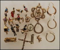 A small collection of yellow metal charms to include a policemen, post box, John Bull having a small