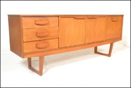 A retro 20th Century teak wood sideboard credenza having a configuration of cupboards and drawers