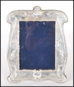 A silver hallmarked Art Nouveau style photo frame having repousse decoration of kingfishers and