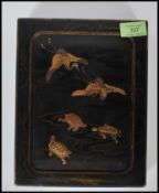 A 20th Century Japanese lacquered box having a cen