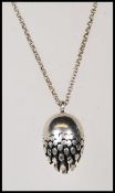 A hallmarked silver pendant necklace having an egg shaped pendant with concentric circle design.