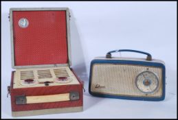 A vintage 20th Century cased Vidor portable radio having hinged lid and carrying handle finished