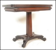 A 19th century Regency solid mahogany tea table. Raised on a quadruped base with scroll feet.