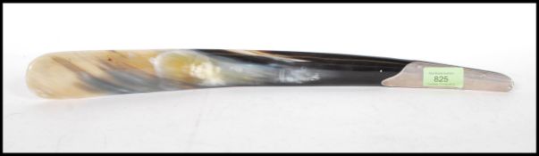 An 20th Century shoe horn having a silver hallmarked handle with a horn shaft. Hallmarked