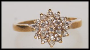 A hallmarked 9ct gold and diamond cluster ring. Hallmarked Sheffield 1995. Estimated diamond