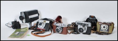 A collection of 20th Century vintage cameras to include Empire Baby the wonder boxed camera, Bell