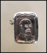 A silver vesta case of large form being cast in relief with a portrait of King George V. Hinged