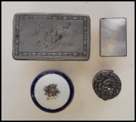 A silver hallmarked pill pot having an enamelled top having a central basket of flowers on white