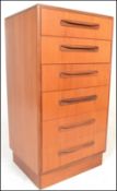 A retro 20th Century circa 1970's G-Plan teak wood Kelso chest of six drawers being raised on an