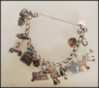 A vintage silver hallmarked heart lock charm bracelet having 16 silver and white metal charms to