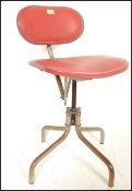 A retro 20th Century industrial machinists swivel chair having a quadrapod base and central column