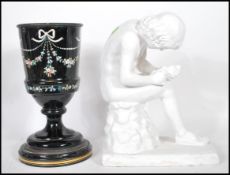 A 20th century plaster sculpture / study of a young man pulling a thorn from his foot sat on a