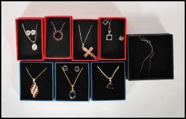 A collection of eight silver ( stamped 925 ) pendant dress necklaces, set with coloured paste