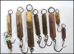 A collection of early 20th Century Salter spring fishing scales of varying sizes.