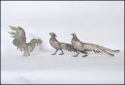 A group of 20th Century silver white metal birds to include a male and female pheasant, along with a