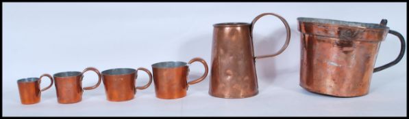 A collection 19th and 20th Century copper measures to include 1/2 pint, 1.5 gill, 1 gill, 1/2 gill