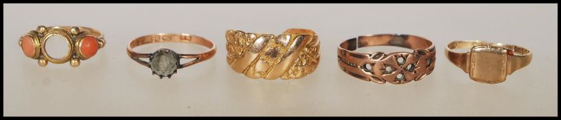 A collection of 18ct and 9ct scrap gold rings. 18ct gold ring with floral decoration approx weight
