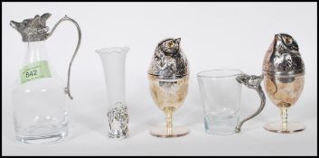 A 20th Century glass claret jug of small proportions having a pewter top in the form of a fox with a