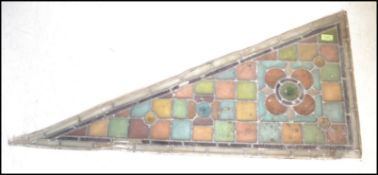 An early 19th Century leaded stained glass Arts and Crafts architectural panel of triangular /