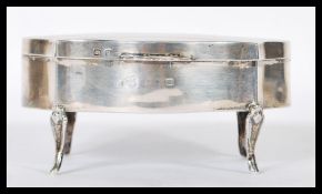 A late Victorian silver hallmarked ladies jewellery casket being raised on cabriole legs with engine