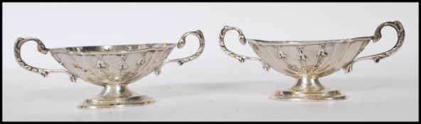 A pair of early 20th Century Asprey & Co silver hallmarked table salts of reeded oval form with twin