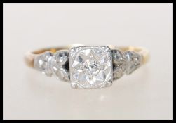 An Art Deco 18ct gold, platinum and diamond ring having a square head with  illusion set round cut