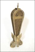 An early 20th century peacock fan fireguard having fold out brass fan sections with pierced
