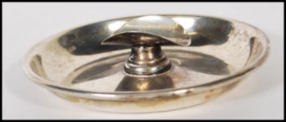 A silver early 20th Century cigar ashtray, the circular tray with central cigar support / rest,