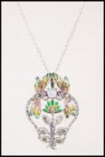 A ladies silver Art Nouveau necklace pendant having plique a jour butterflys over flowers.Set to a