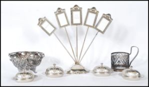A silver plated photo frame constructed from an oval base with scrolled shell detailing having