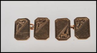 A pair of 9ct gold gentleman's cufflinks having engine turned decoration, each united by chains.