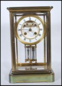 An early 20th Century Mappin &  Webb gilt brass bevelled glass panelled mantel clock having a
