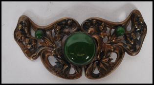 An early 20th Century Art Nouveau metal belt buckle having repousse floral decoration and pierced