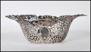 A 20th Century stamped sterling silver rococo style bon bon dish having scrolled decoration rims