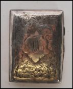 An early 20th Century silver hallmarked vesta case being engraved with foliate detailing to the