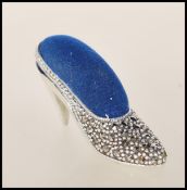 A silver and marcasite contemporary designed VIctorian manner pin cushion in the form of a ladies