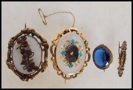 An early 19th century mourning brooch set with turquoise having a central hair locket together