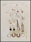 A collection of silver jewellery to include two rings, a pair of hooped earrings, a pair of black