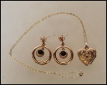 A 9ct stamped link chain necklace with a gold metal heart shaped locket pendant together with a pair