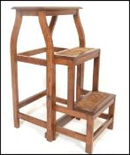 An early 20th Century Arts and Crafts metamorphic folding set of library steps / ladder, the three