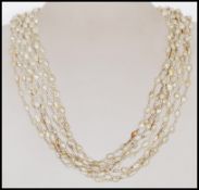 A 20th Century ladies pearl necklace consisting of eight strings with baroque pearls and white metal