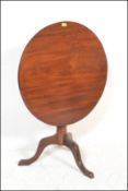 A 19th century George III mahogany tilt top occasional / dining table. Raised on tripod splayed