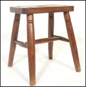 A Victorian 19th century beech and elm country stool. Raised on ring turned legs with a