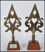 A pair of unusual 20th century trade union banner head brass speak heads. Each raised on mahogany