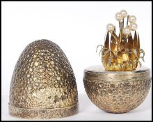 A silver hallmarked Stuart Devlin ' surprise egg ' having a textured exterior opening to reveal a