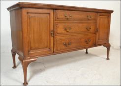 An early 20th Century Edwardian mahogany sideboard credenza by Shoolbred, central bank of three