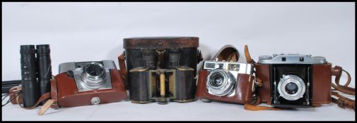 A collection of vintage cameras and binoculars to include 35mm cameras, folding cameras etc.