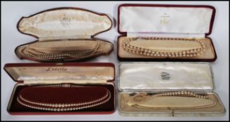 A collection of vintage simulated pearls in their original boxes to include a set of three string