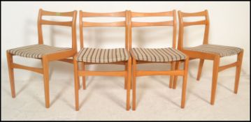A set of 4 20th Century retro beech wood rail back dining chairs having a beech frame with check